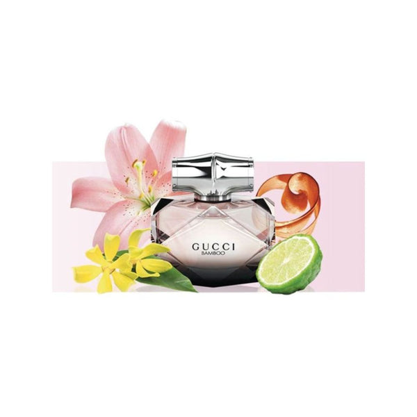 Gucci Bamboo perfume bottle with flowers and a lime on a pink background