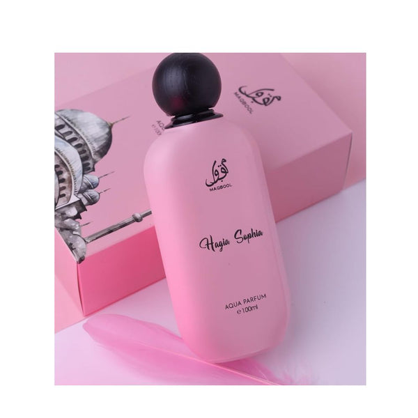 Pink perfume bottle with black cap on a pink background