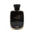 Black perfume bottle with gold text on a white background