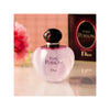 Dior Pure Poison perfume bottle with packaging on a reflective surface